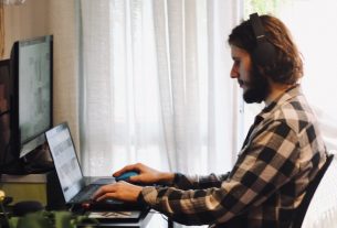 man sitting on a chair looking at the computer