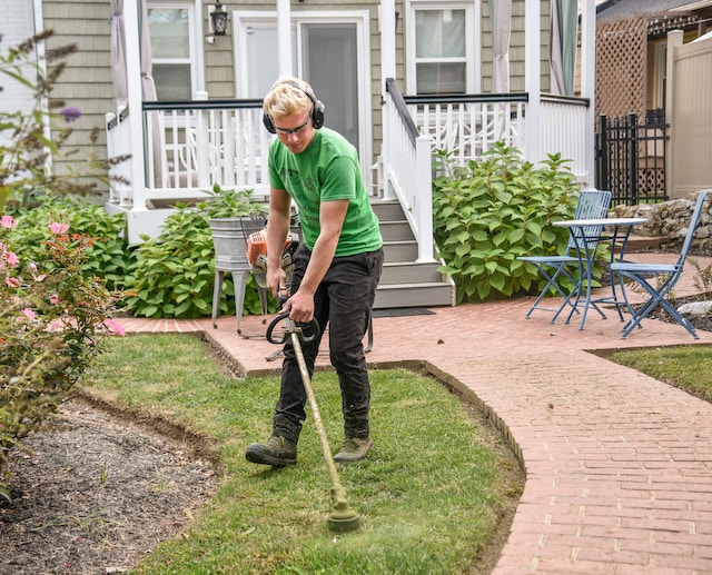 landscape gardener moving grass
